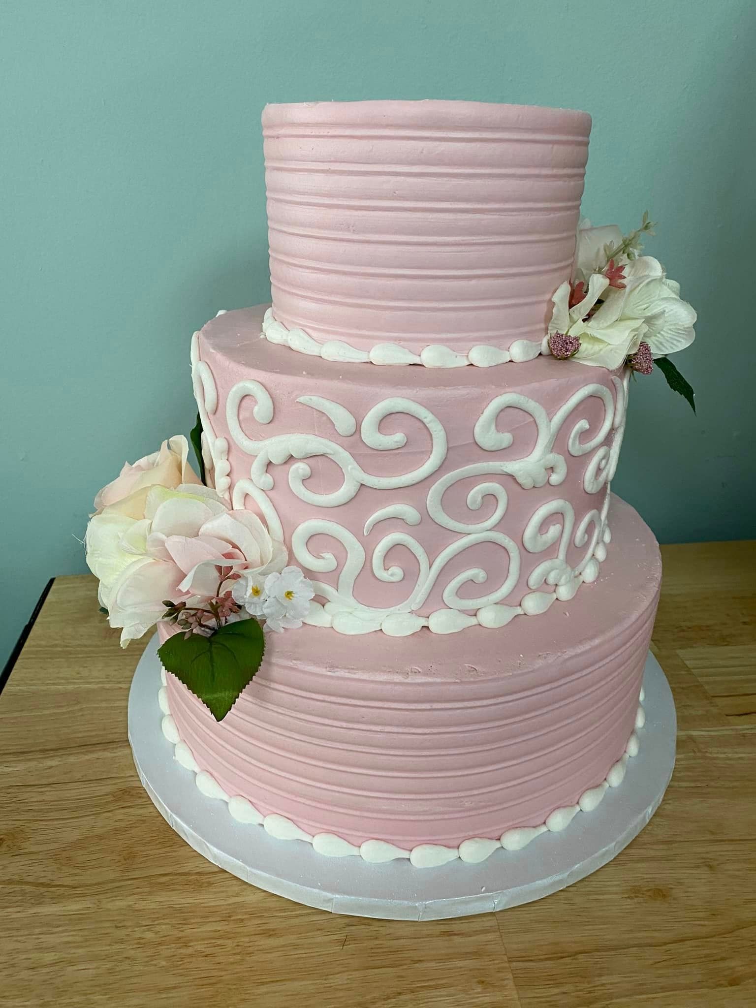 Cake with textured swirled icing, in white and pink ombre coloring