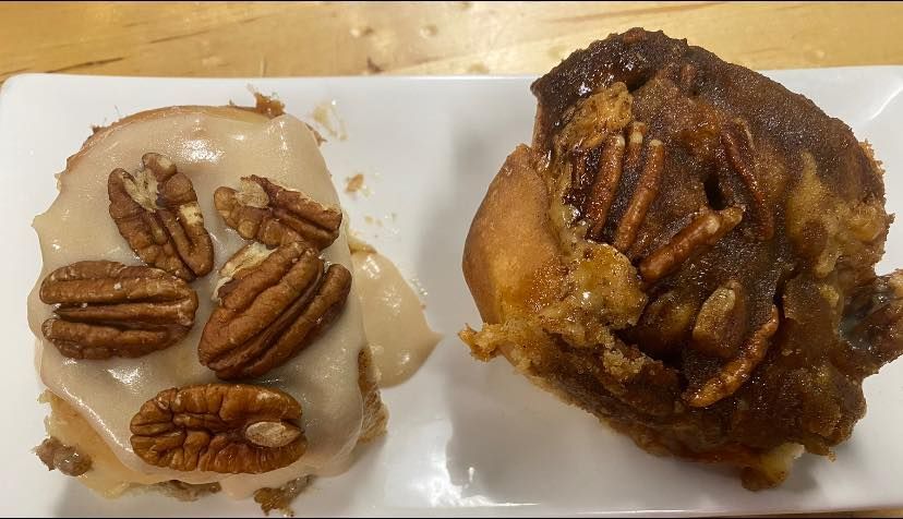 Two sticky bins with icing and walnuts