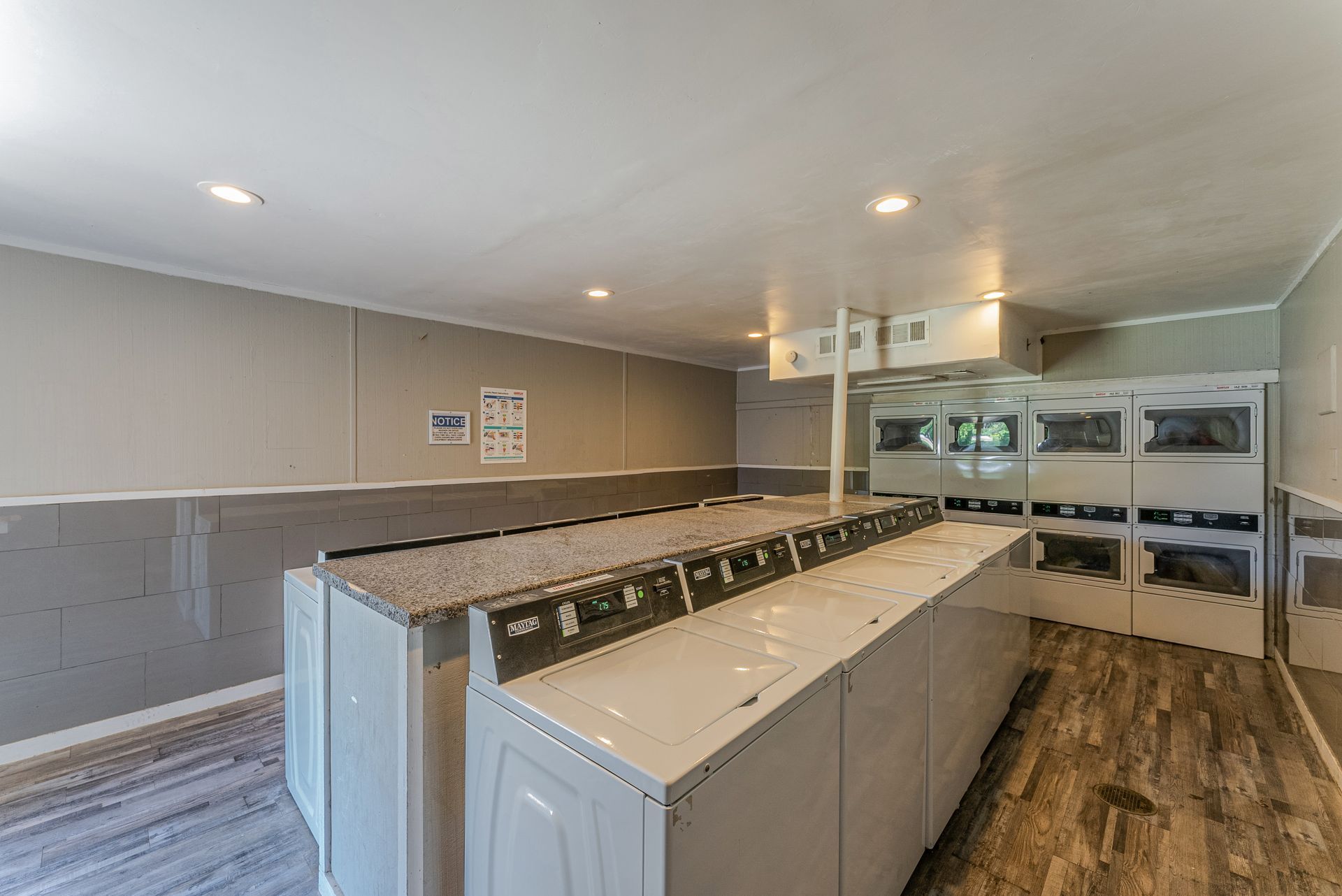 A laundromat with a lot of washers and dryers.
