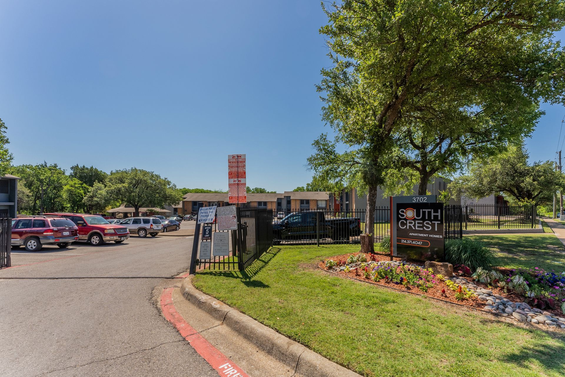 A parking lot with cars parked in front of a building.