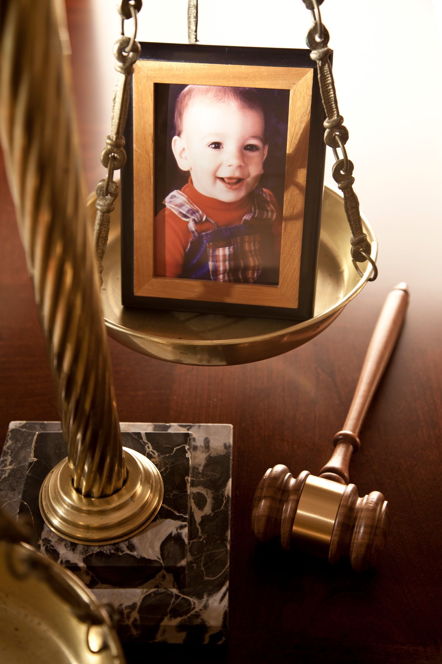 Gavel, scales of justice, and young boy illustrating child custody cases at Bates Law Firm PLLC in Anson County, NC.