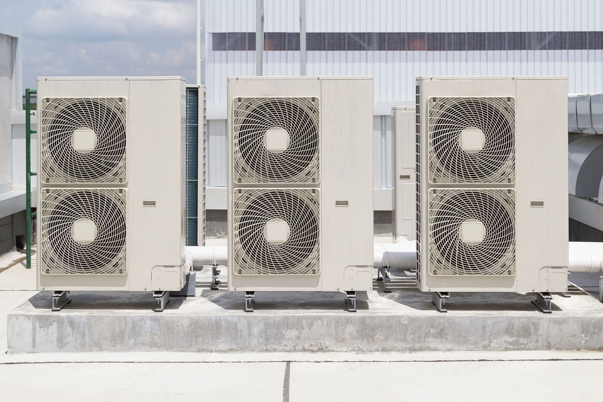 Condenser unit or compressor on a roof of an industrial plant building with a sky background. Condenser unit or compressor on a roof of an industrial plant building with a sky background.
