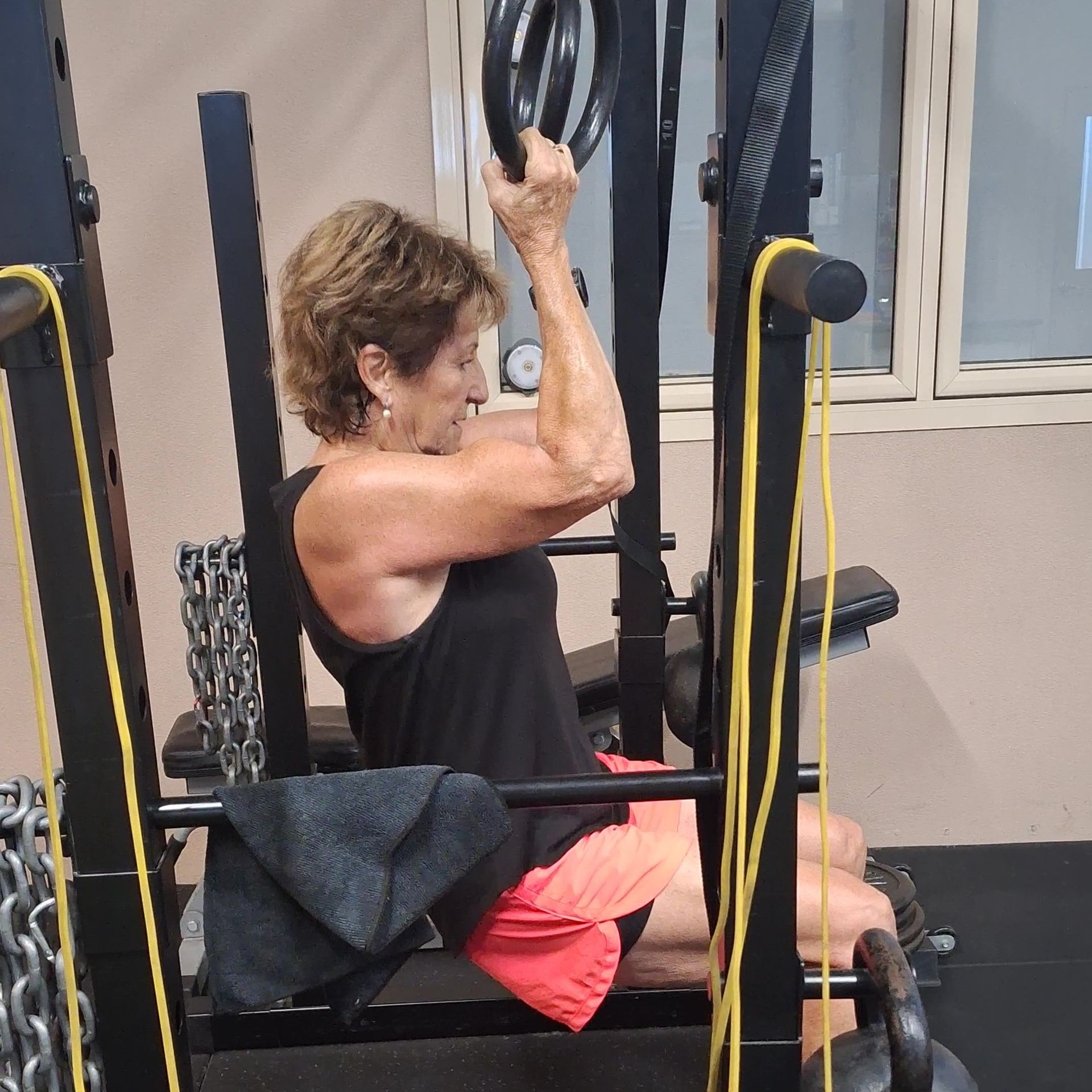 A gym with a green track and a lot of dumbbells.
