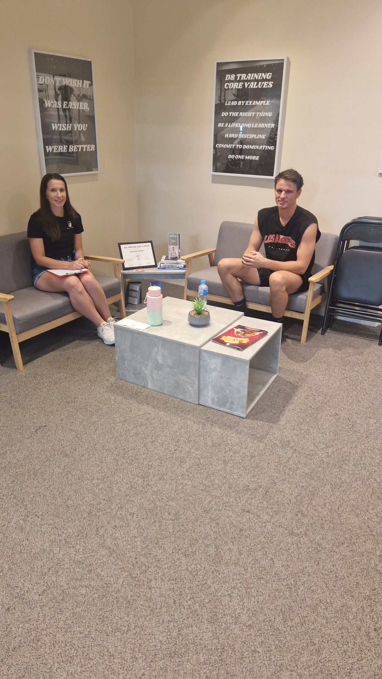 A group of people posing for a picture in front of a sign that says bungcafe