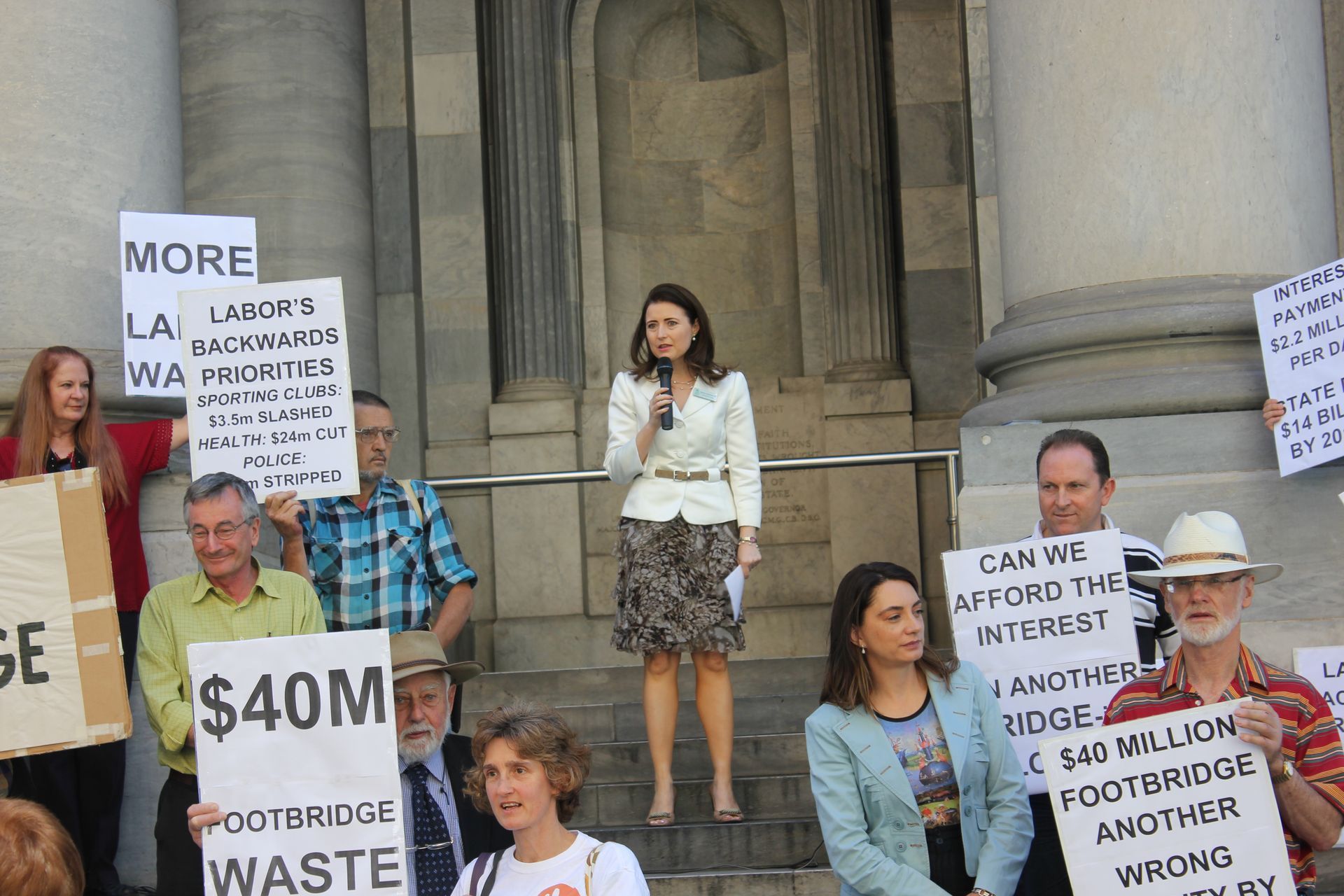A group of people holding signs including one that says $ 40m