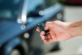 Man Hand Unlocking Car — Alarm Install  in Elk Grove, CA
