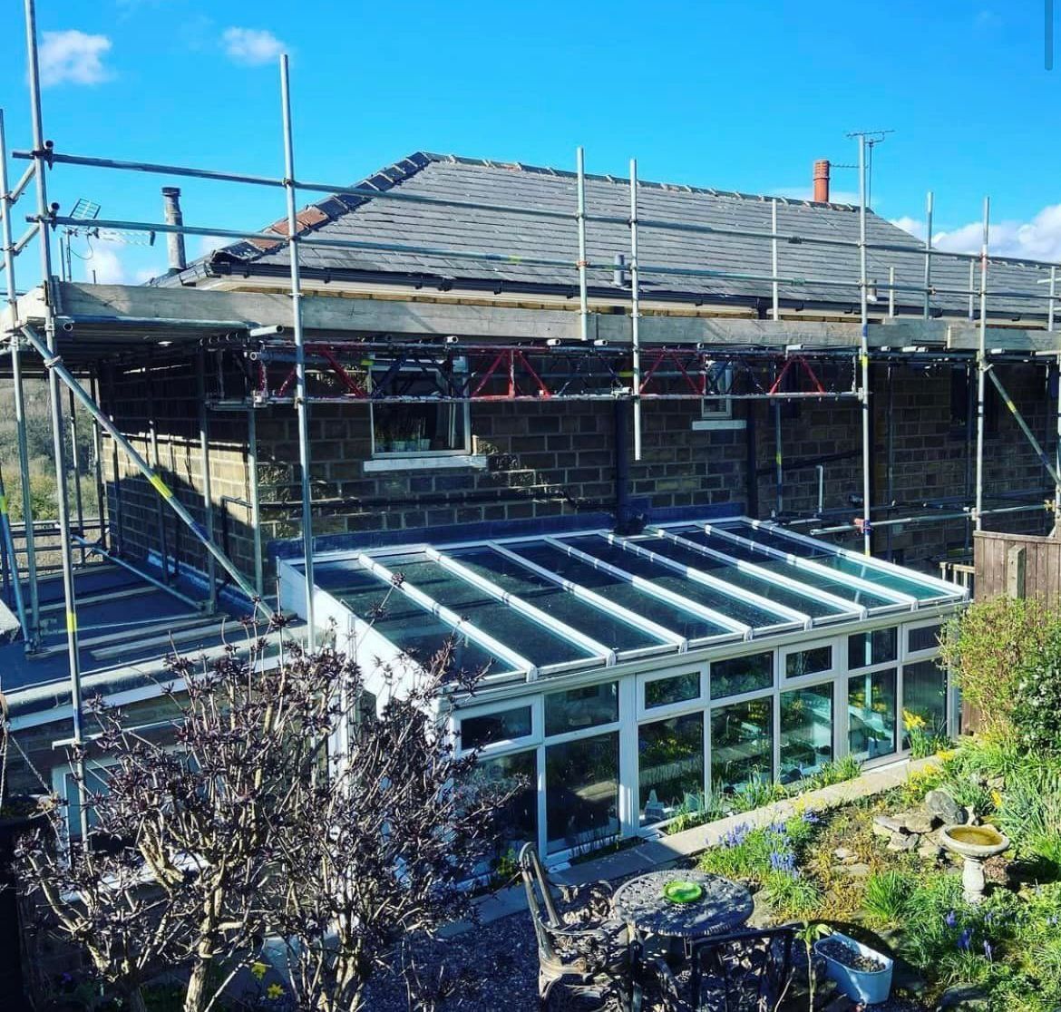 A house is being built with scaffolding around it.