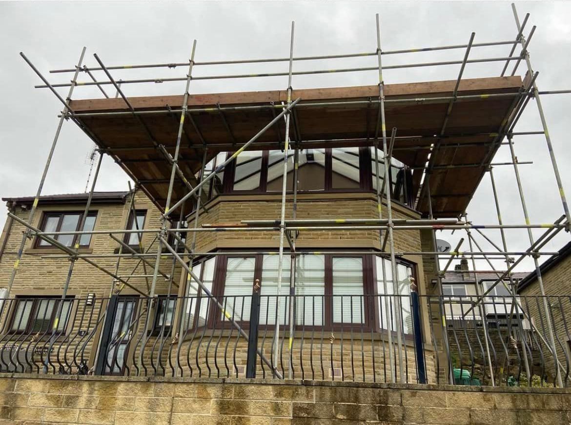 A large house with scaffolding on the side of it.