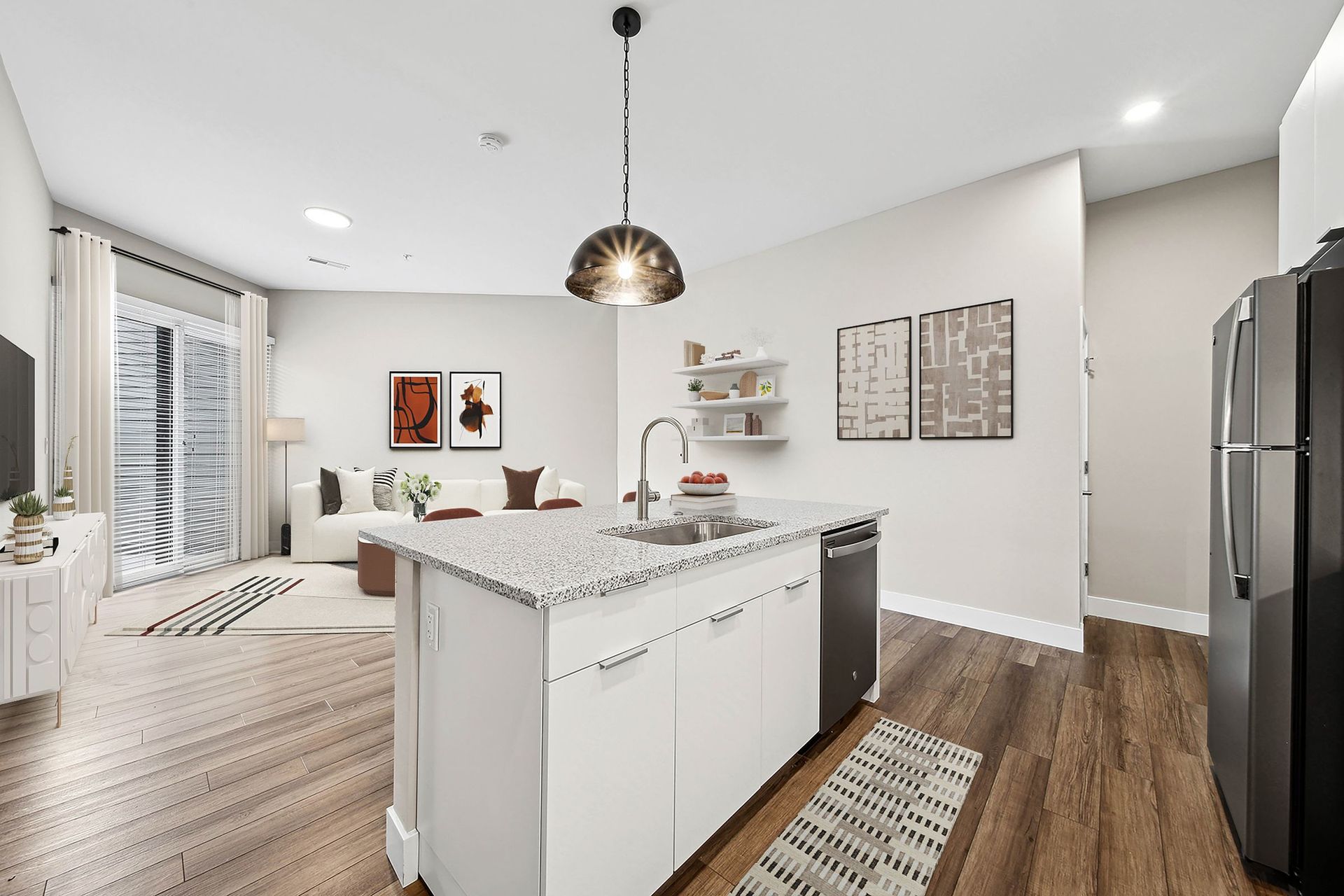 Open-concept kitchen with island, granite countertop, and stainless steel appliances.