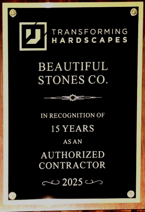 A black award plaque honoring Beautiful Stones Co. for 15 years as an authorized contractor in 2025.