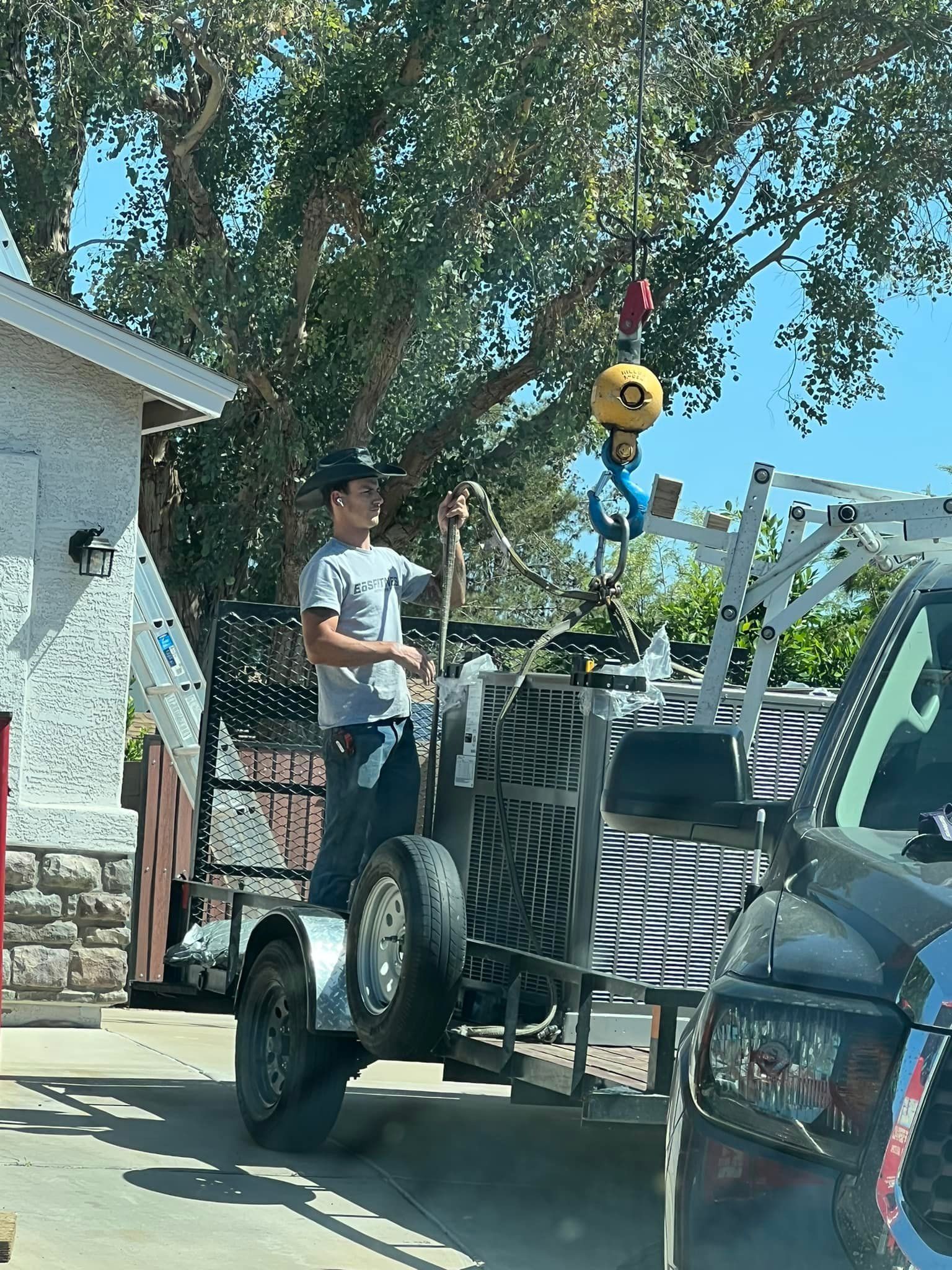 Air conditioning units with toolbox and gloves in backyard.