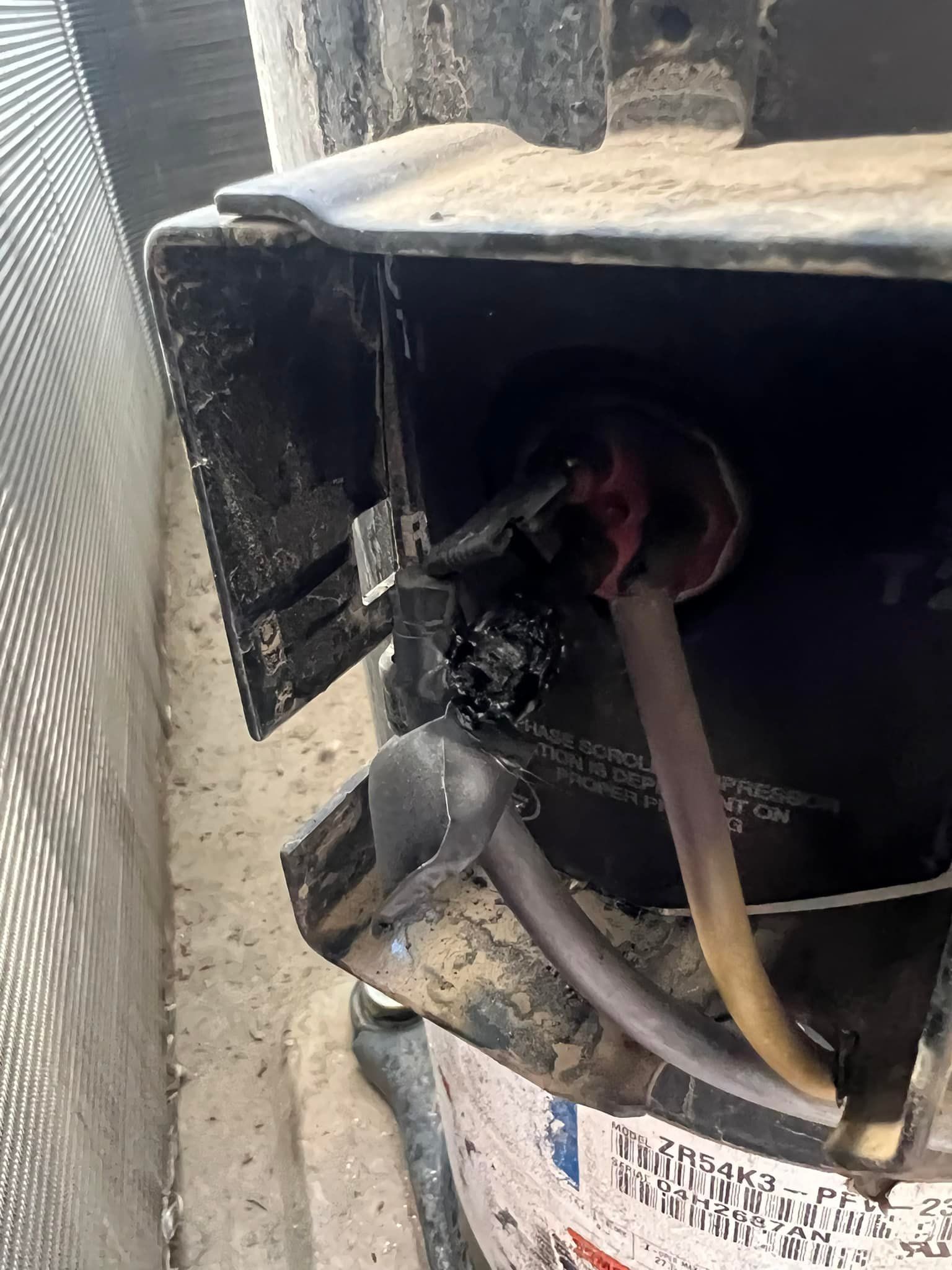 Air conditioning units with toolbox and gloves in backyard.