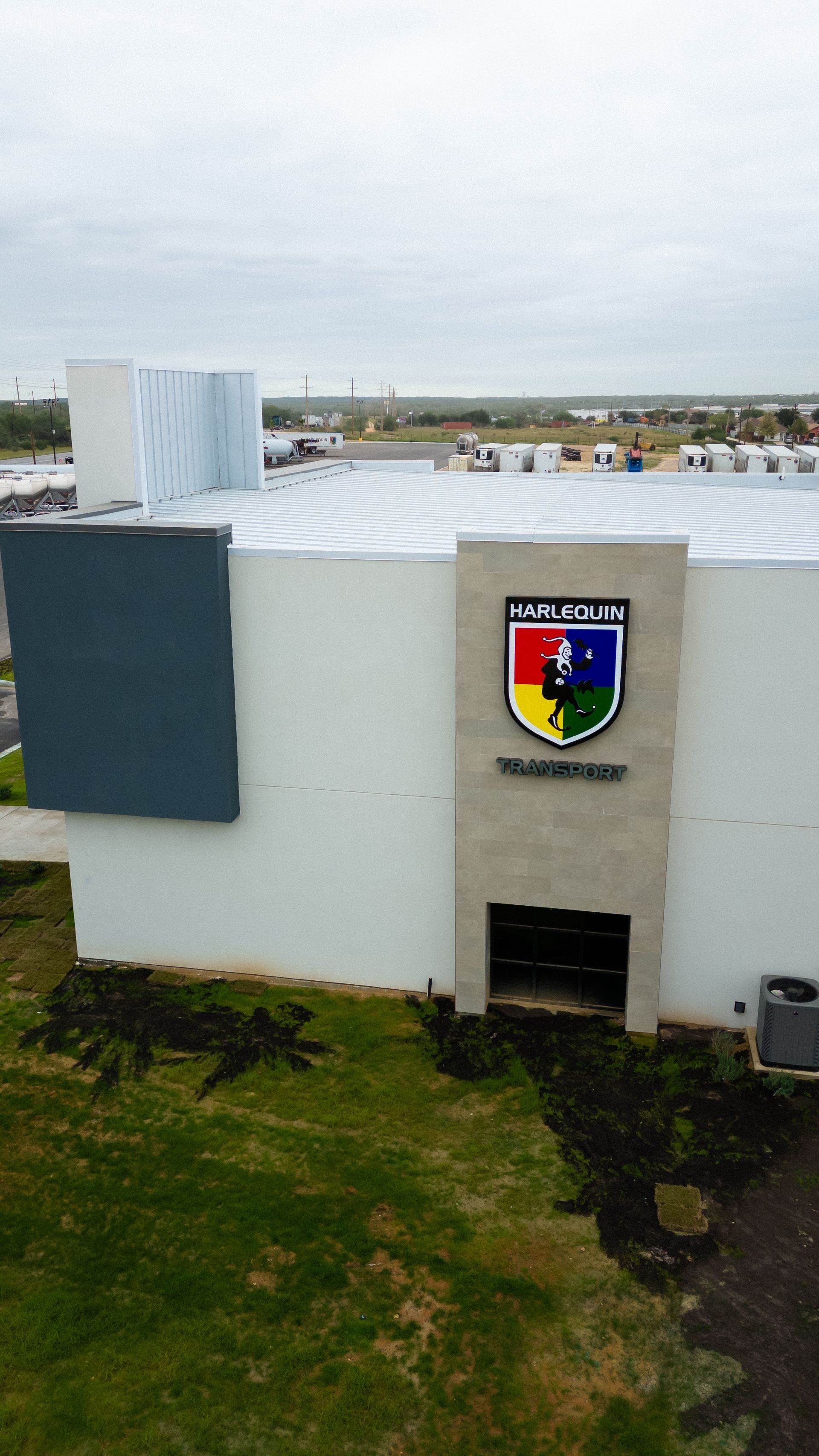 An aerial shot of the side of the Harlequin Transport office. 
