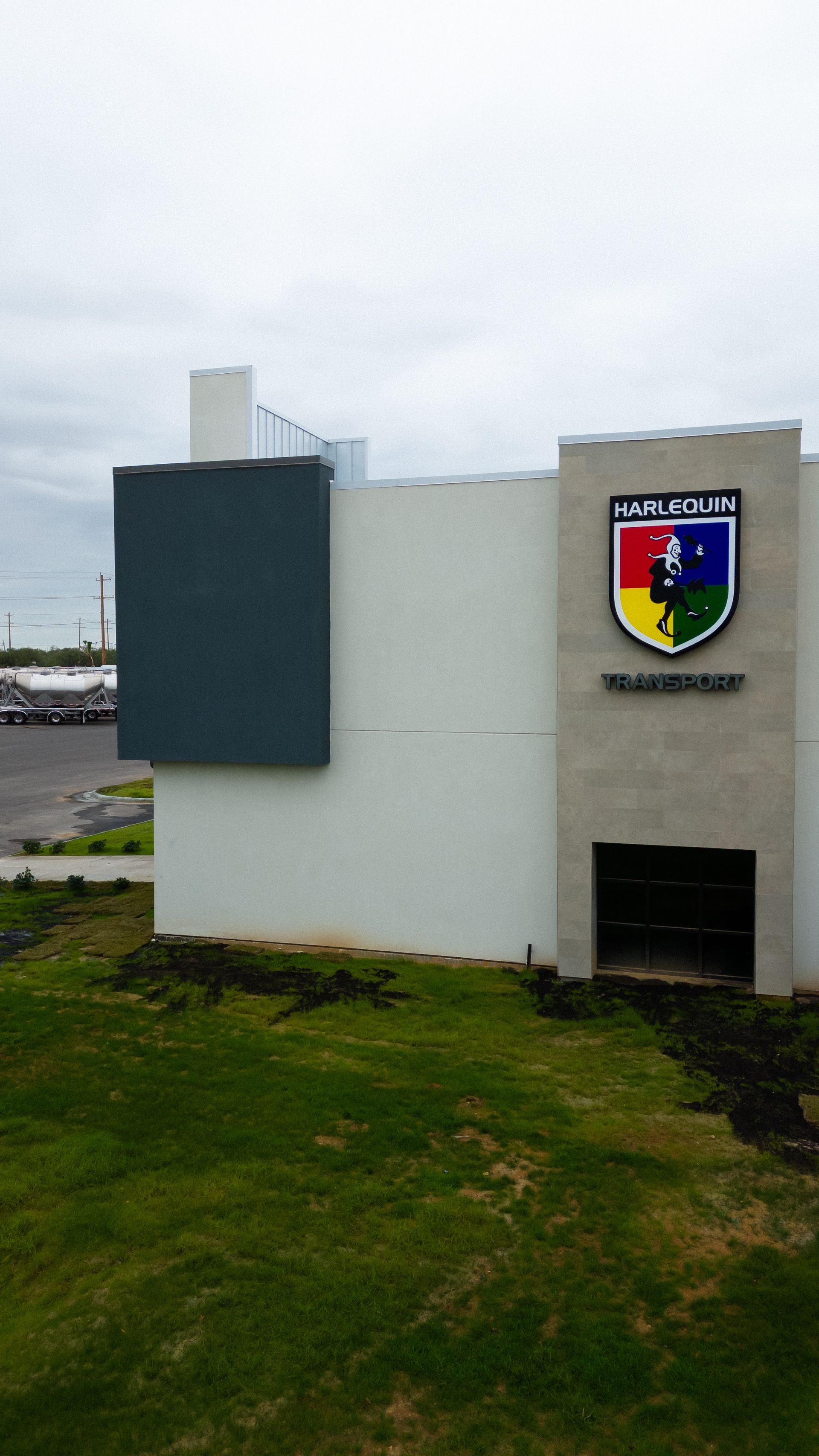 The side of the office building of Harlequin Transport.
