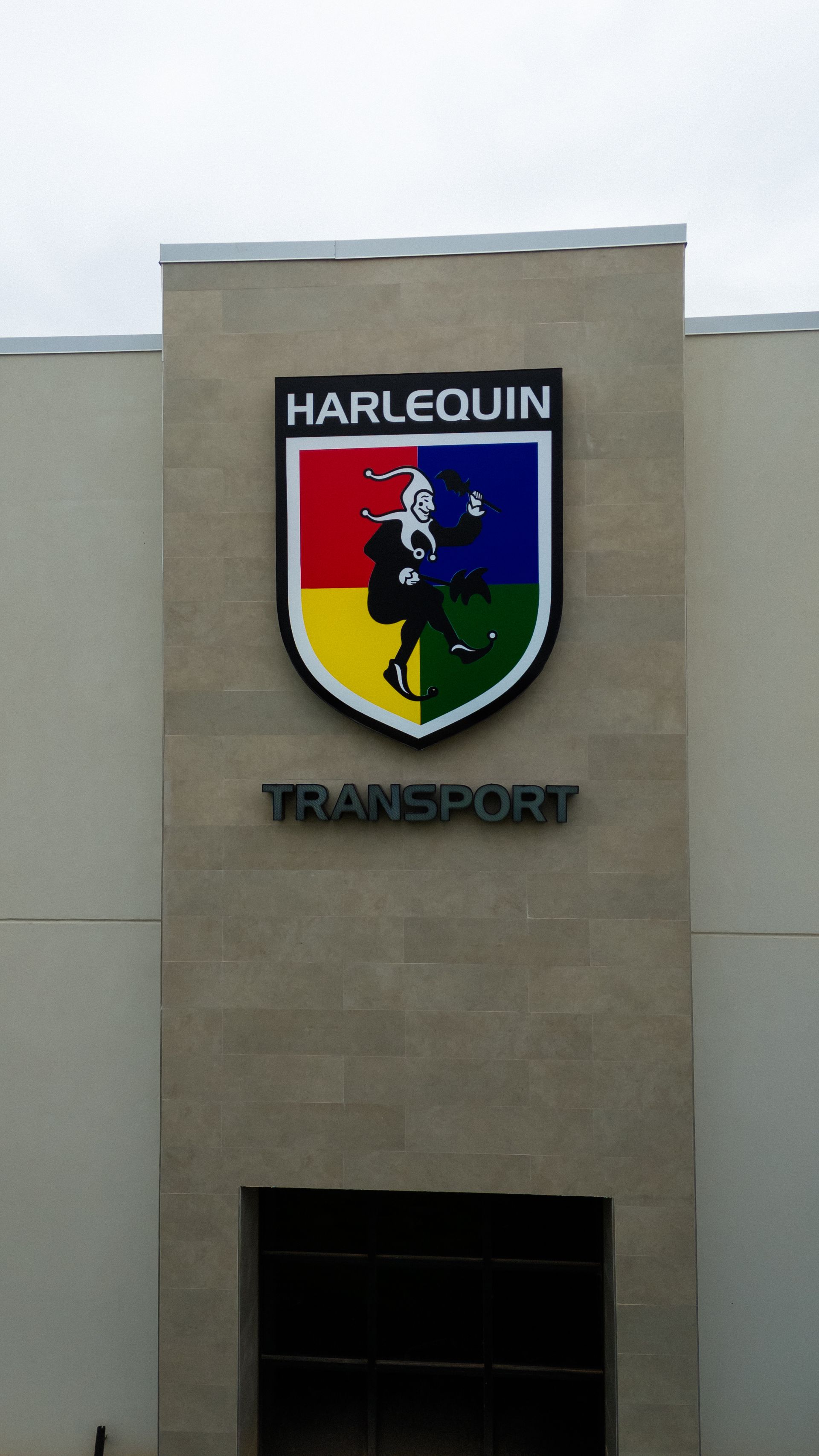 The canopy sign and entrance of Harlequin Transport,  a Freight forwarding service in Laredo, Texas