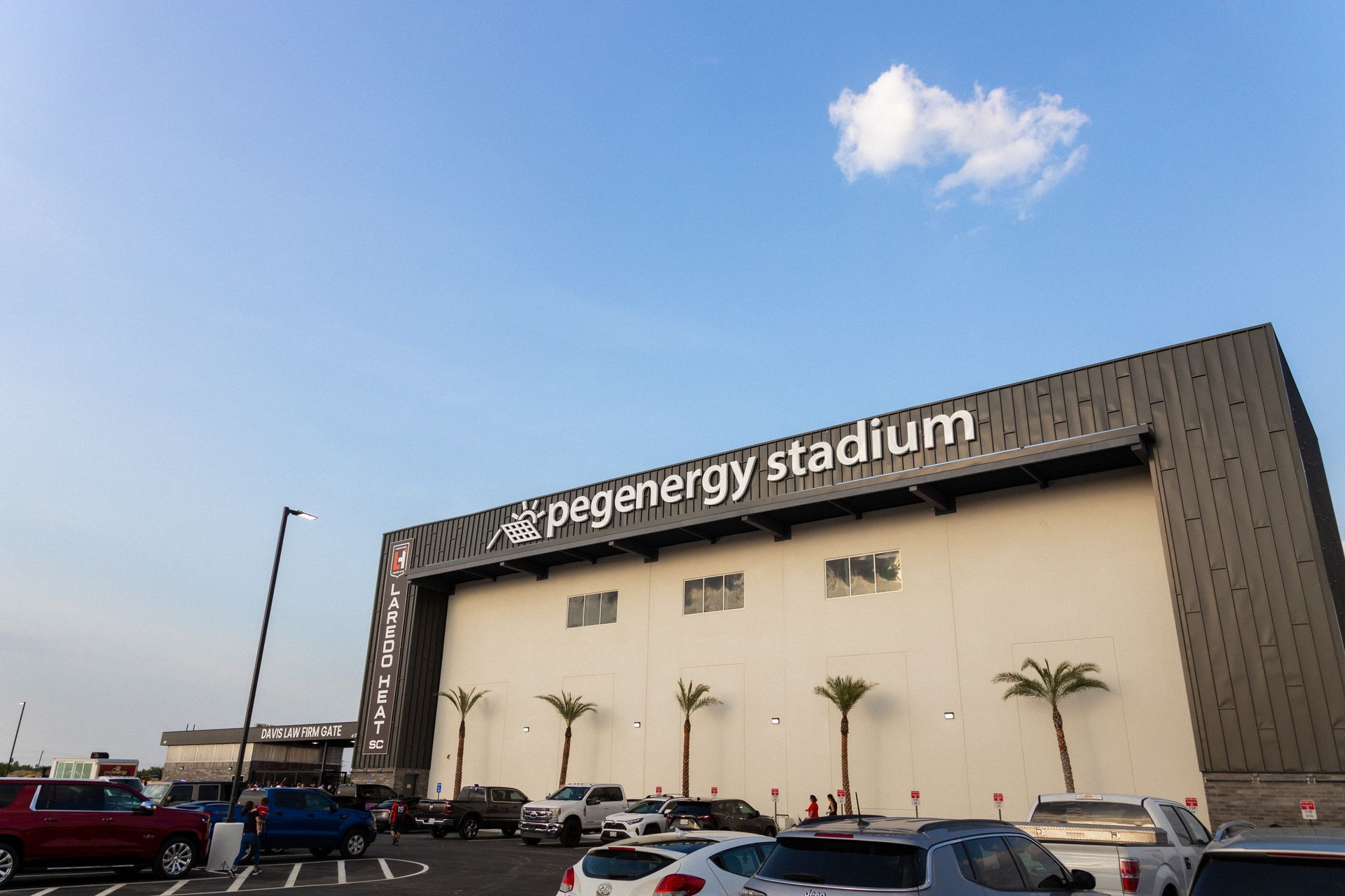 pegenergy stadium and its parking lot during the daytime. 
