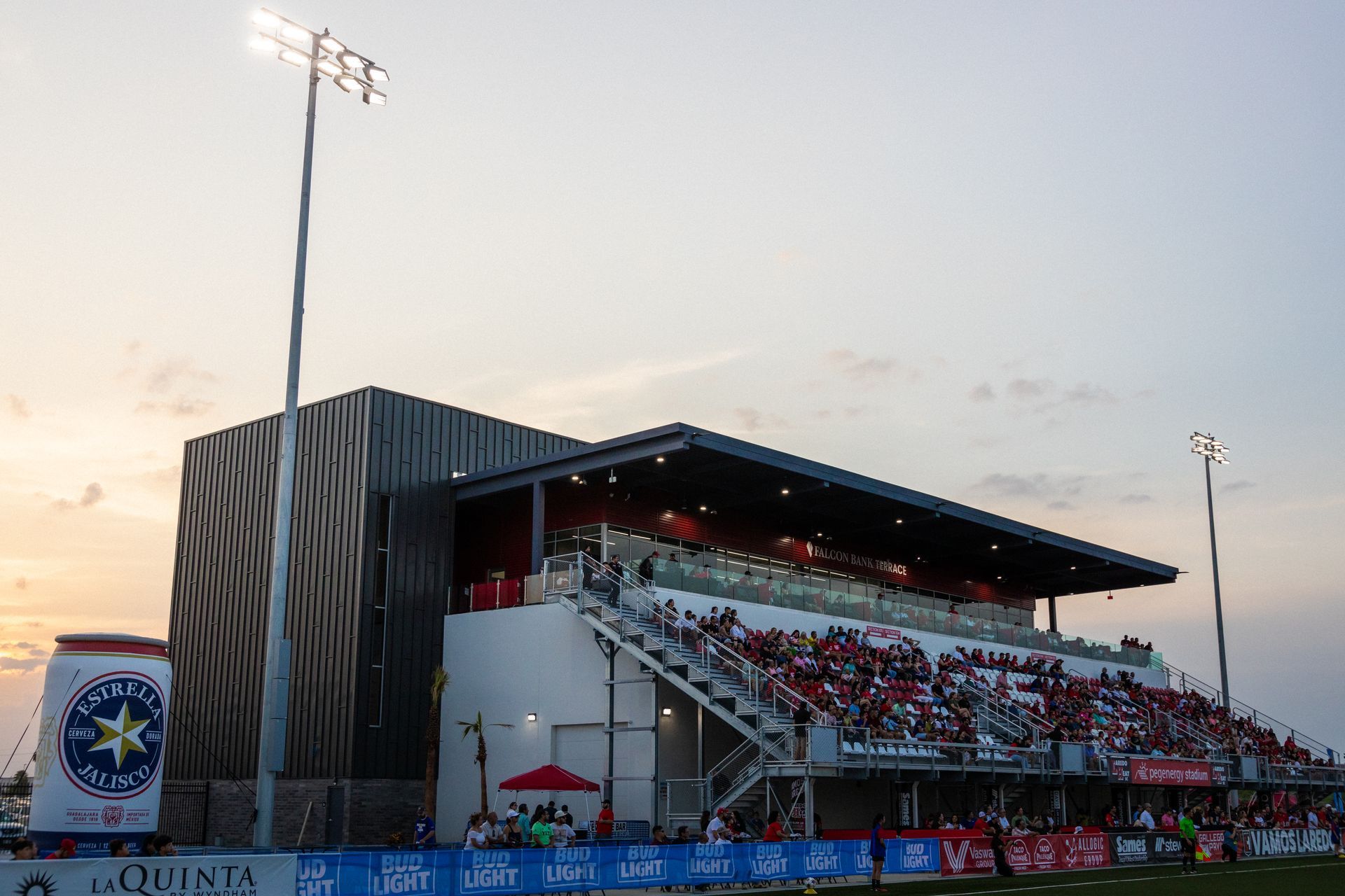 The stands of Laredo's PEG Energy Stadium filled with fans. An inflatible Jalisco Estrella Can is visible next to the stands.