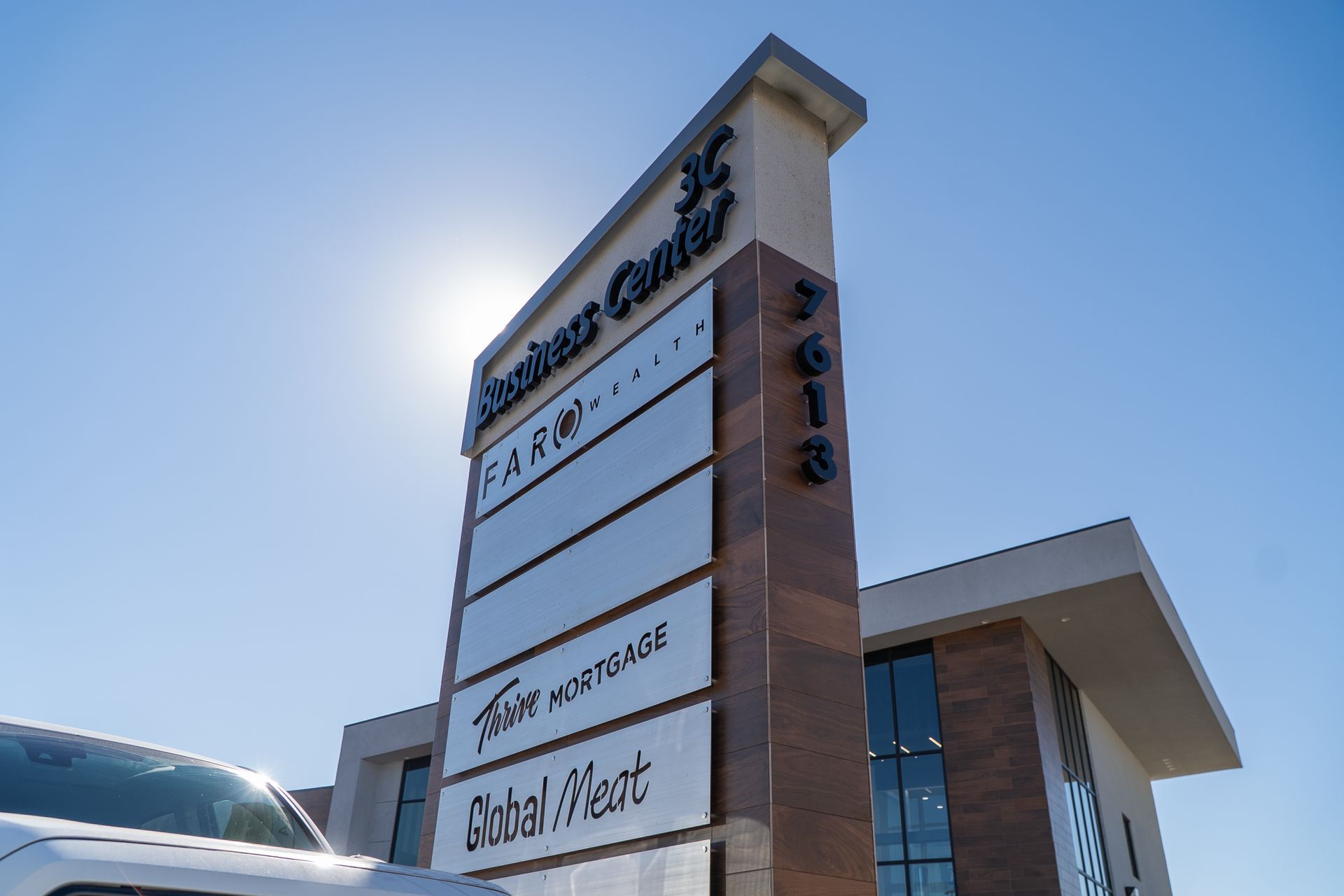 Business Center Plaza's sign. Businesses located here are Faro Wealth, Thrive Mortgage, and Global Meat.