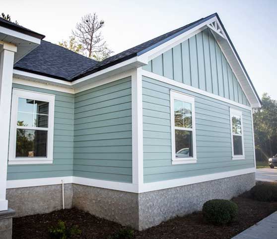 Front view of a brand new construction house with blue siding