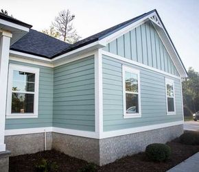 Front view of a brand new construction house with blue siding