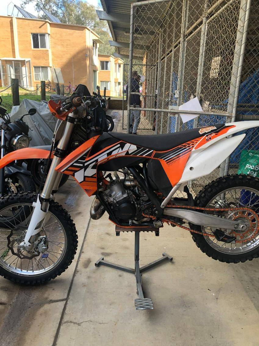 Orange and Black KTM Dirt Bike on a Stand, Outdoors, Near a Building — Bodes All Mechanical In Tathra, NSW