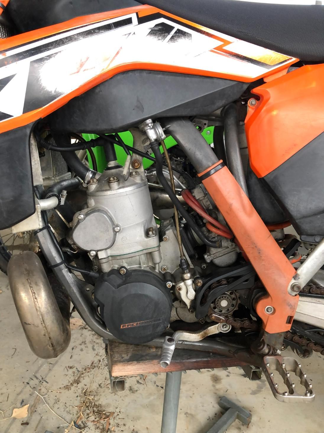 Orange and Black KTM Dirt Bike, Engine and Exhaust Visible, on a Stand Indoors — Bodes All Mechanical In Tantawangalo, NSW