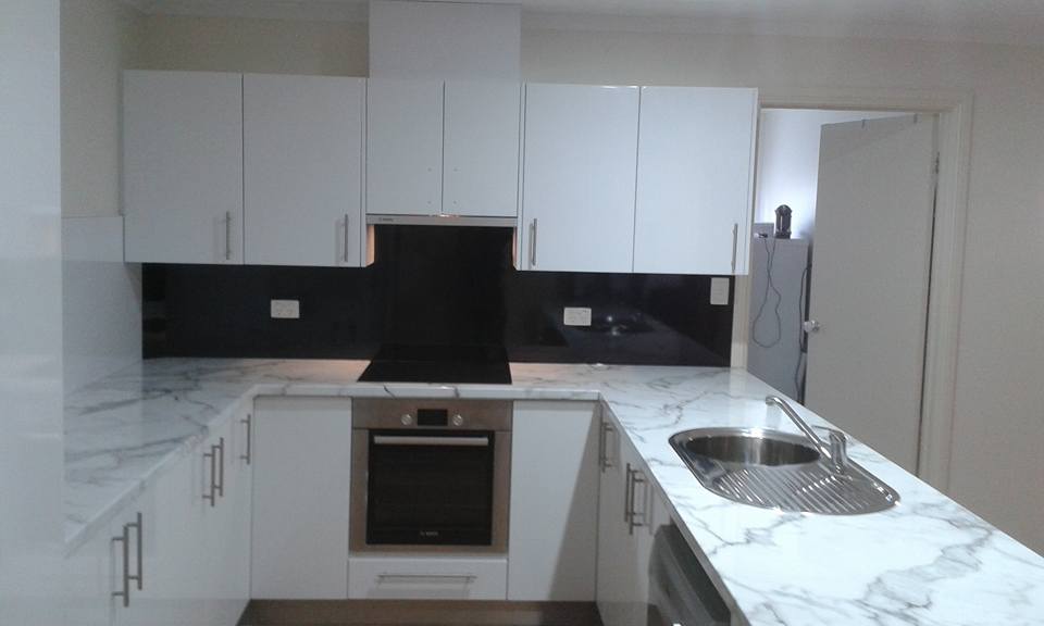 View of kitchen cabinets with counter tops