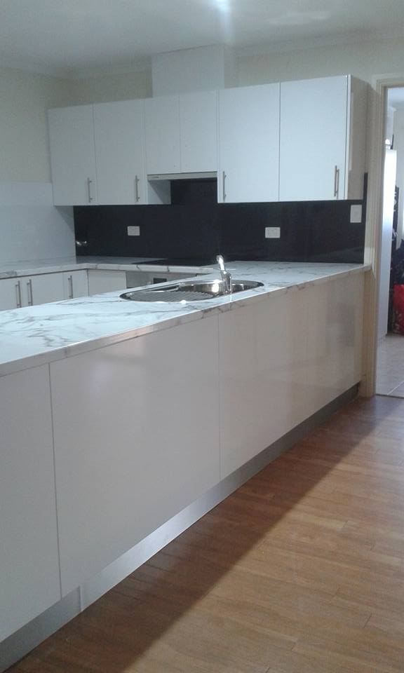 View of kitchen cabinets with counter tops