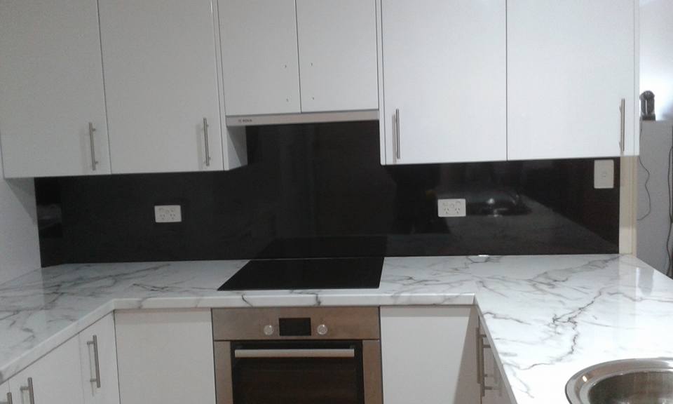 View of kitchen cabinets with counter tops