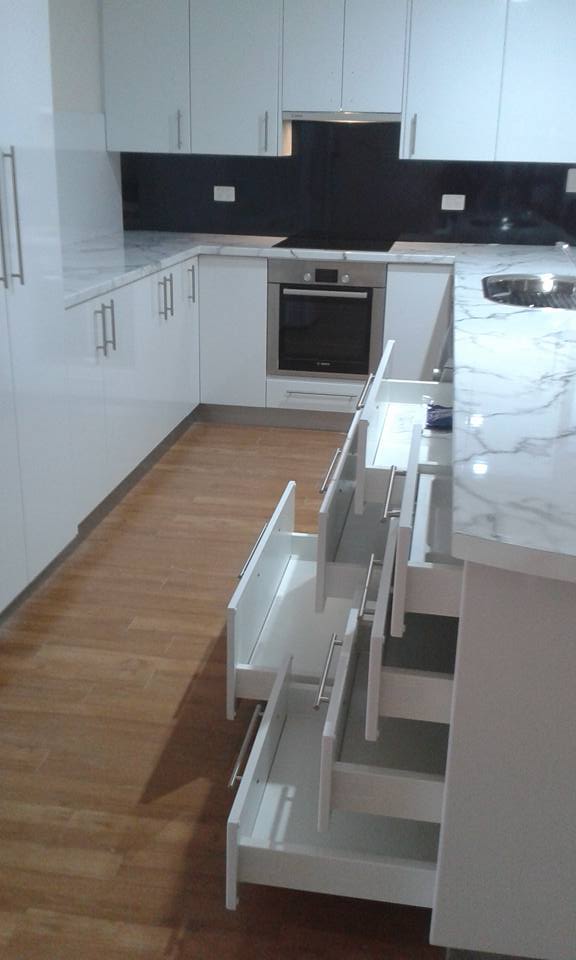 View of kitchen cabinets with counter tops