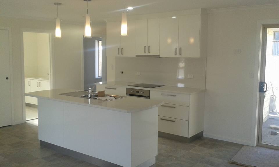 View of kitchen cabinets with counter tops