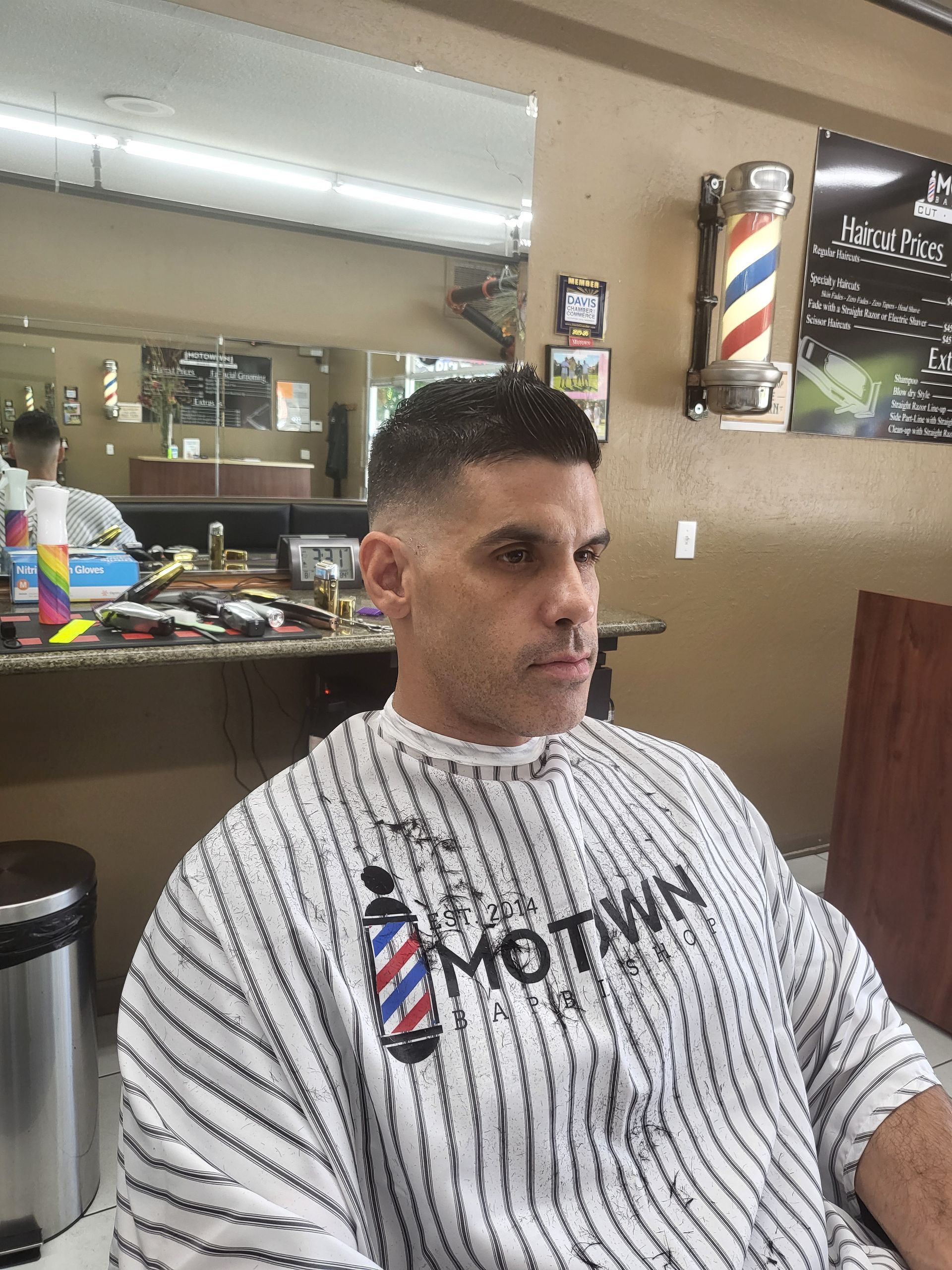 A man is getting his hair cut at a barber shop