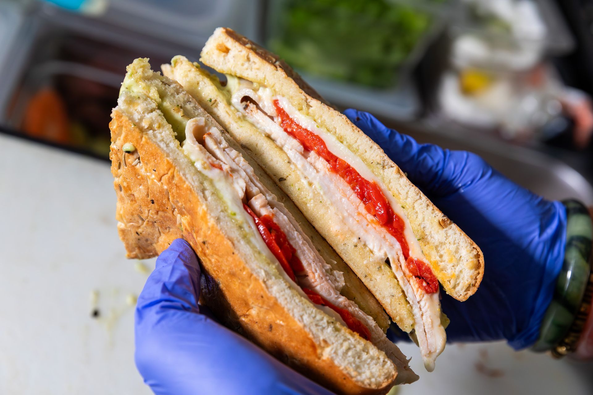 Chilaquiles with eggs, black beans, and toppings on a decorated plate.