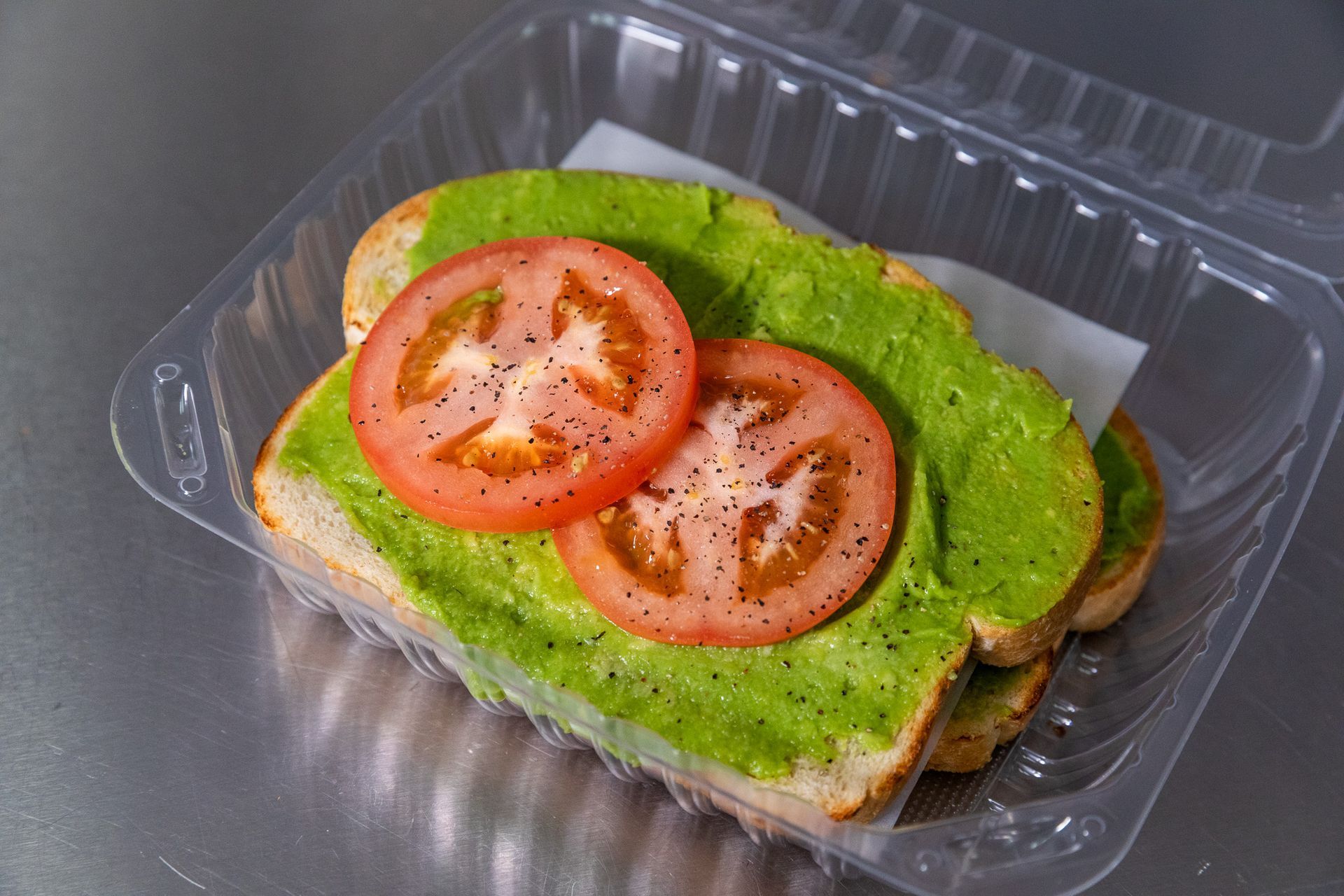Chilaquiles with eggs, black beans, and toppings on a decorated plate.