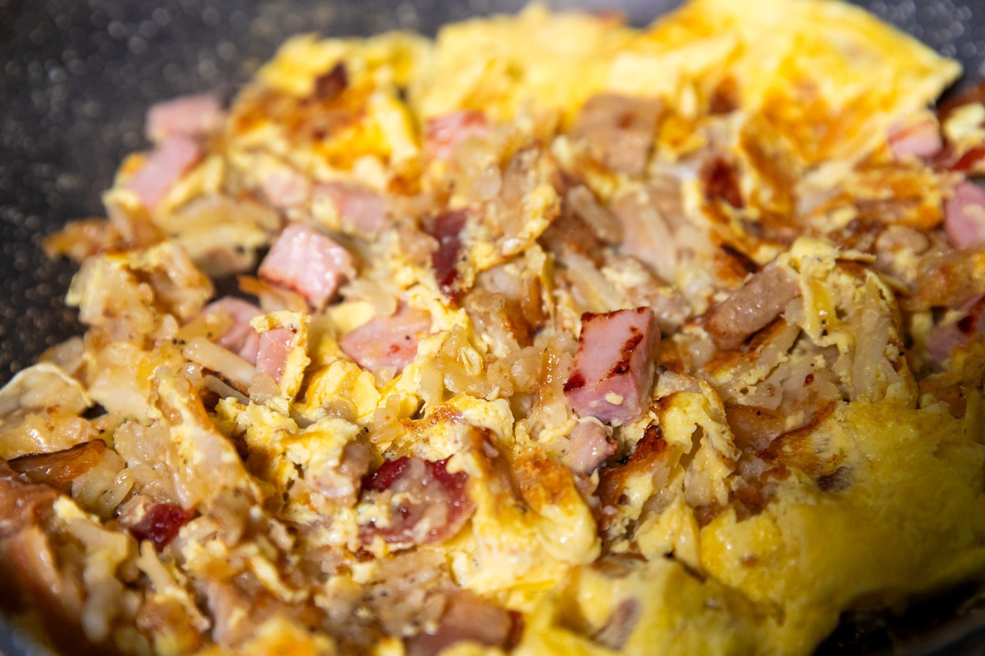 Breakfast plate with fried eggs, toast, sausage, and potatoes.