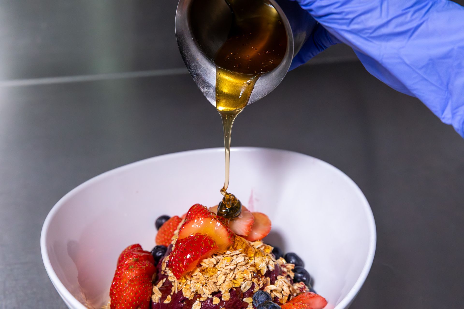 Chilaquiles with eggs, black beans, and toppings on a decorated plate.