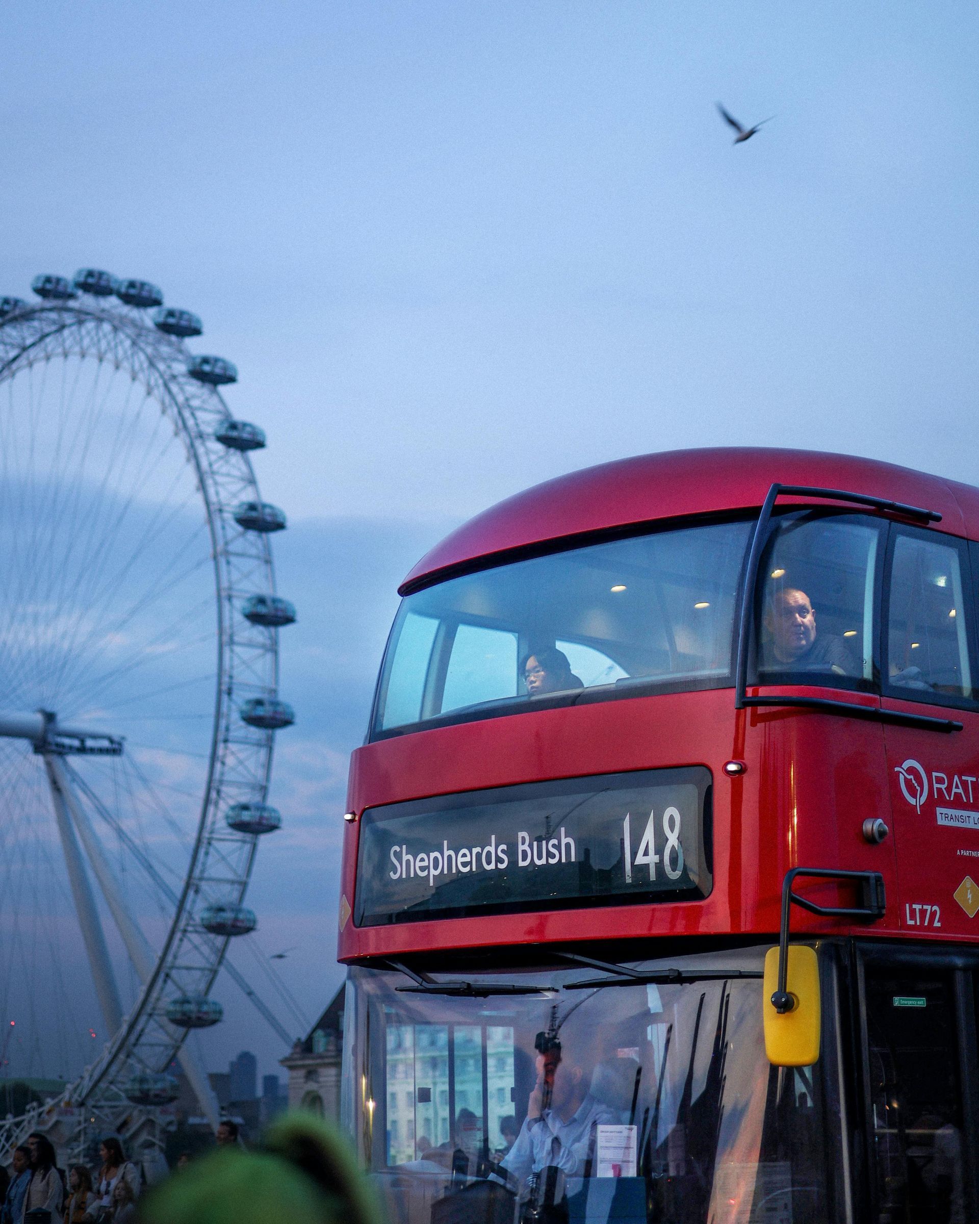 A red double decker bus with the words Shepherds Bush and No. 148 on the front.