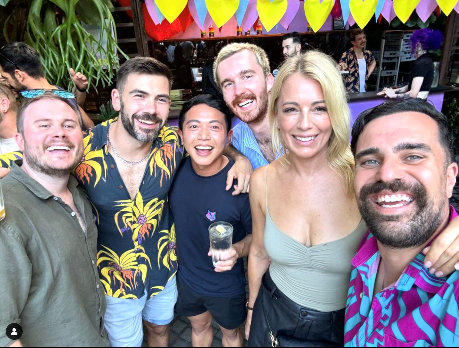 A group of people are posing for a picture at a party.