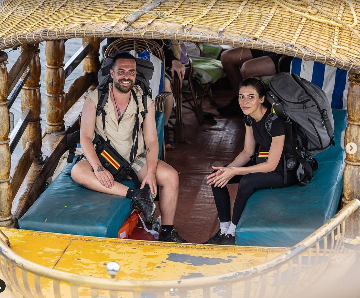 A man and a woman are sitting on a boat.