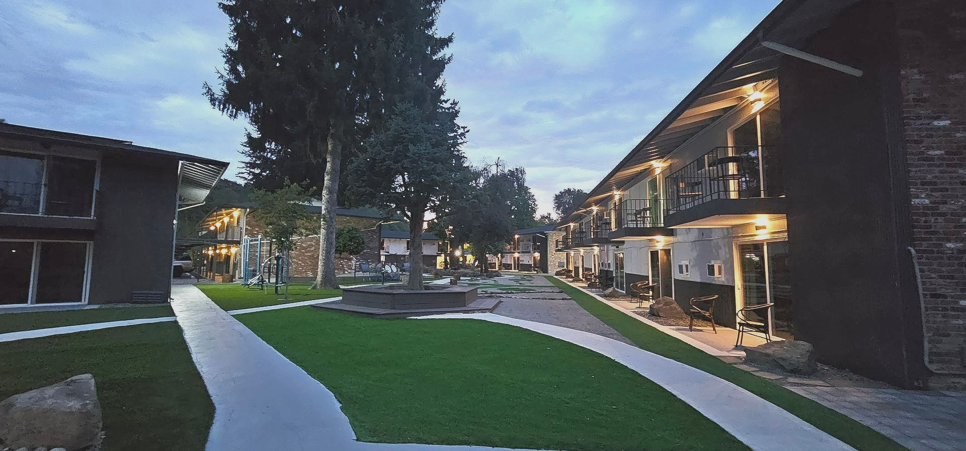 A row of buildings with a walkway between them at night.