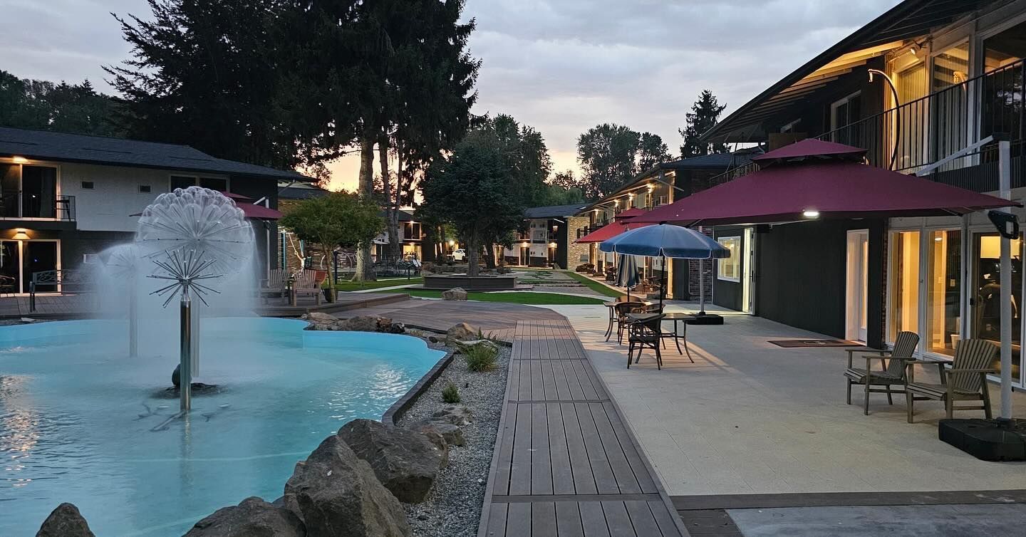 A row of buildings with a fountain in the middle