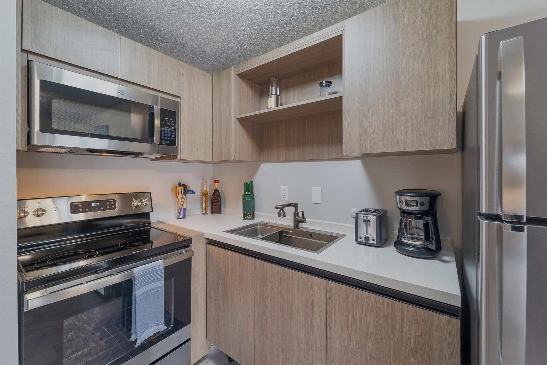 A kitchen with stainless steel appliances and wooden cabinets