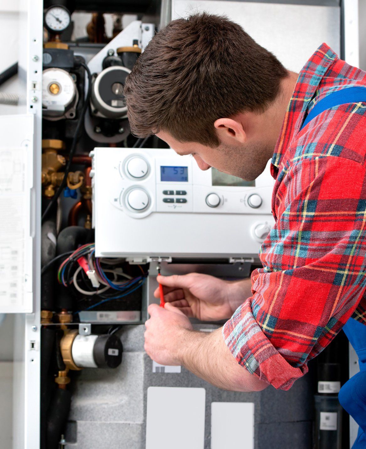 A Man Repairing the Boiler — Douglasville, GA — Douglasville Heating and Air and Appliance