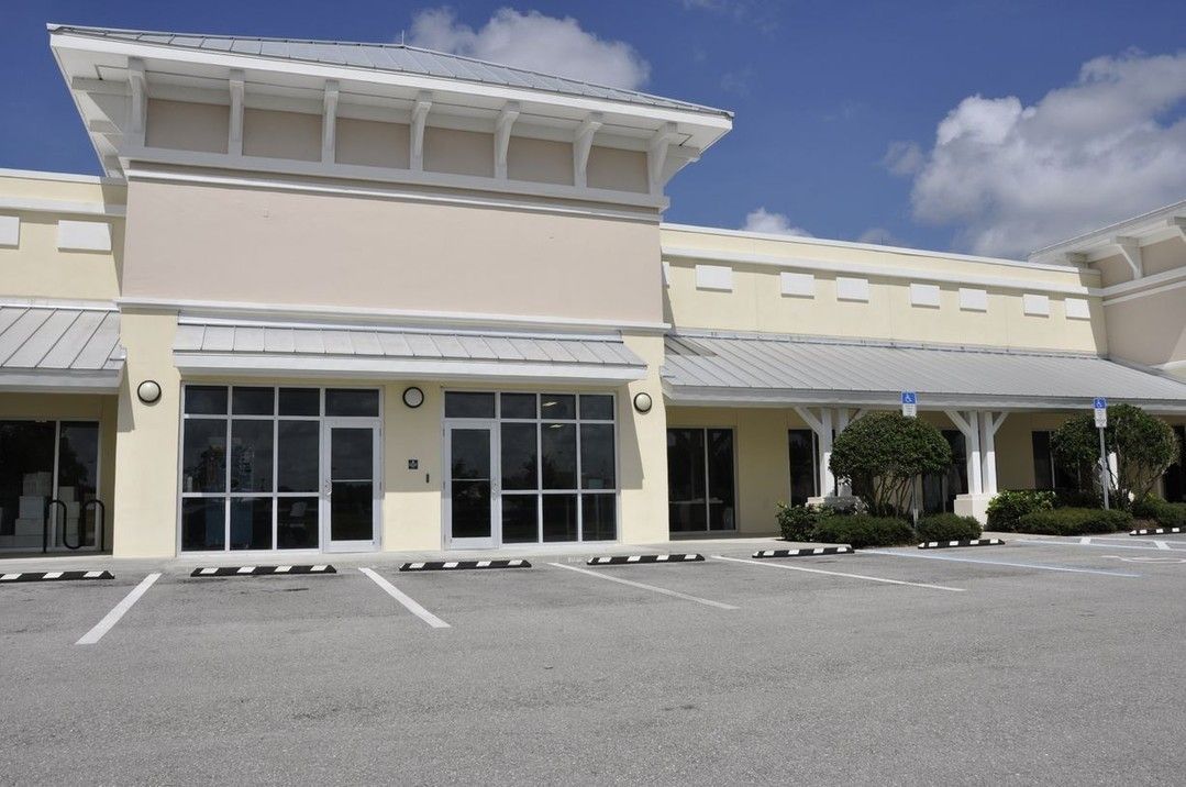 A large building with a parking lot in front of it