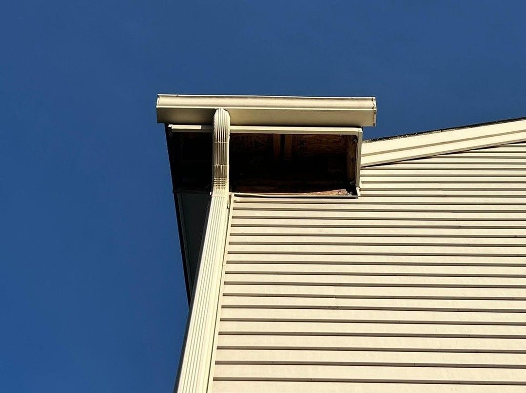 The roof of a house with a blue sky in the background.