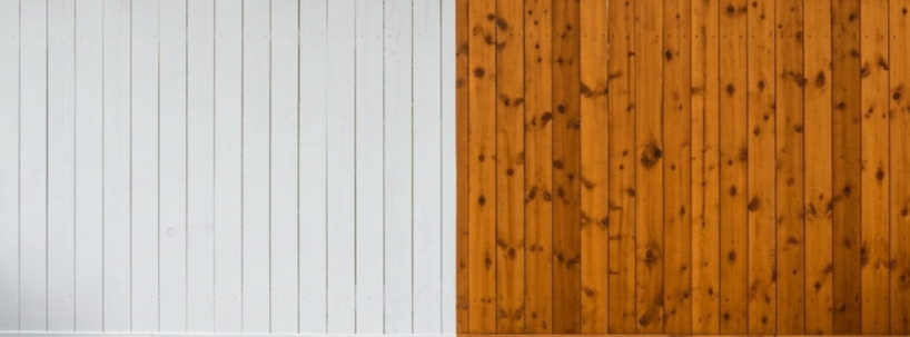 A side-by-side comparison showing a white painted fence section next to a natural stained wood fence section.