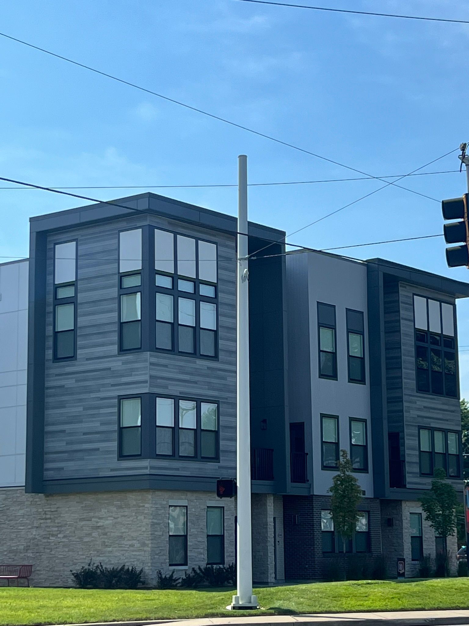 A building with a lot of windows and a traffic light in front of it