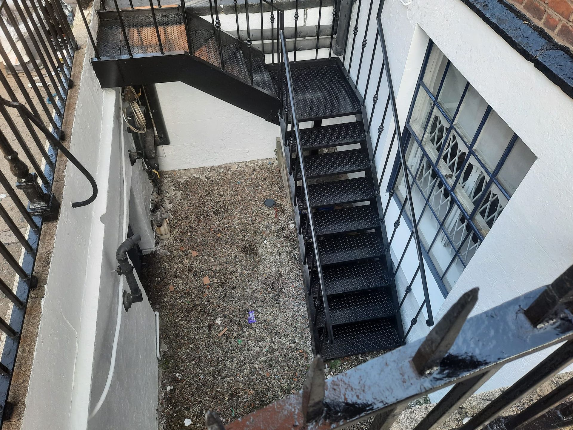 A black staircase leading up to the second floor of a building