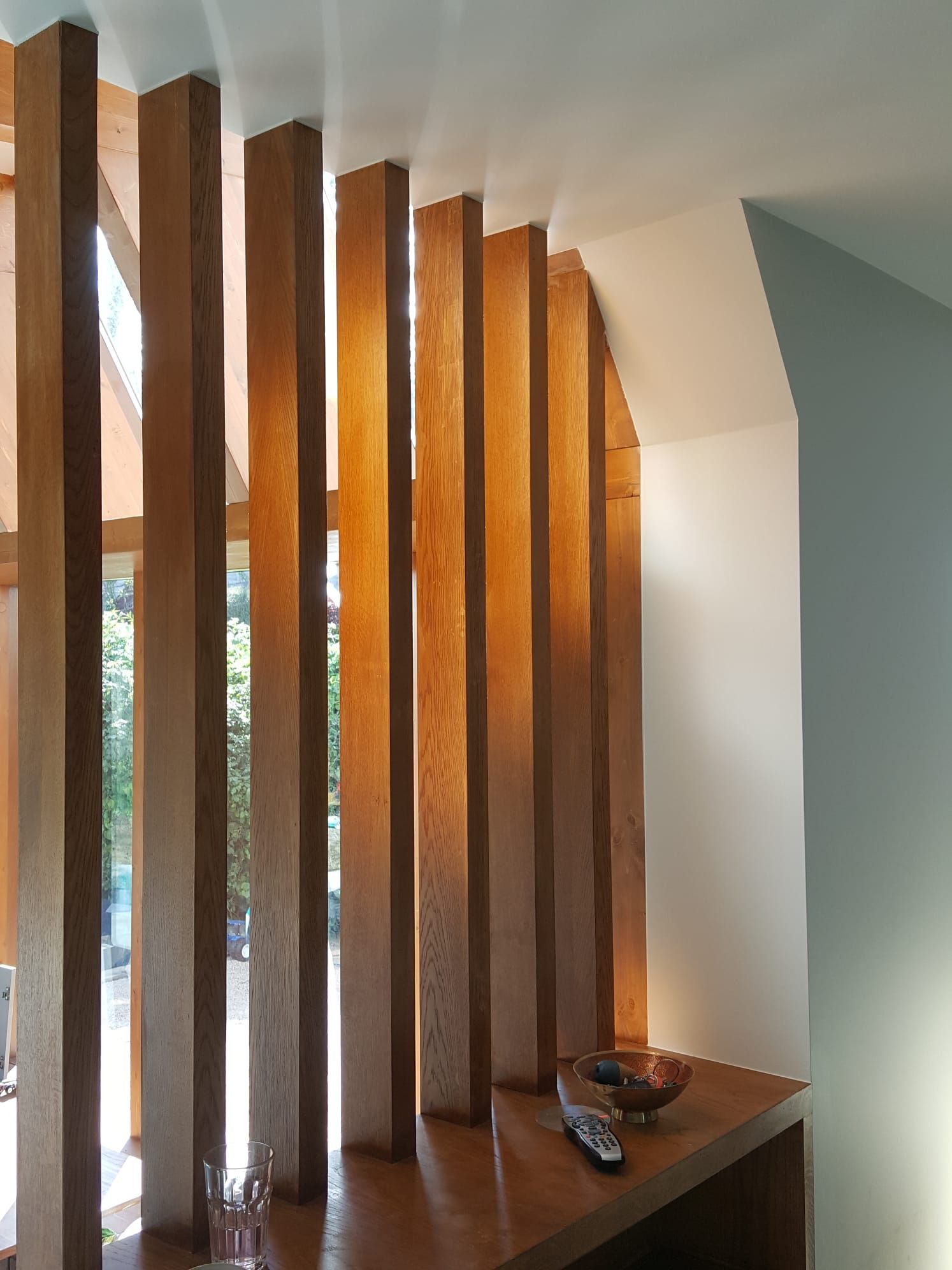 A room with a wooden divider and a window