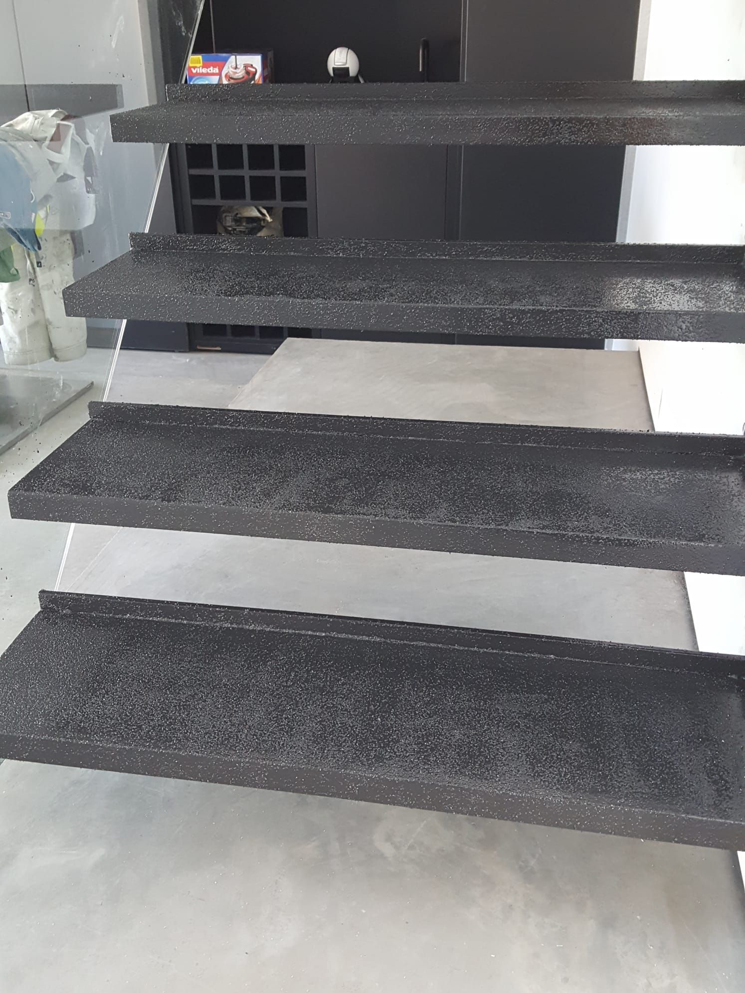 A close up of a set of black stairs in a room.